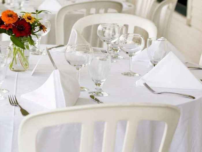 A linened round set with glassware, staged and ready